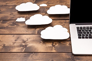 Cloud symbols shown near a laptop representing it cloud services for new york city businesses