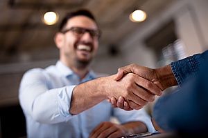local business owner shaking hands with the owner of an IT security solutions firm