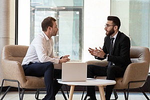 two business men communicating