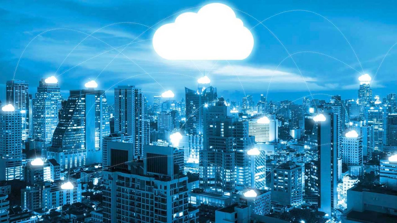 information technology cloud over a cityscape view showing the wide reach of cloud services