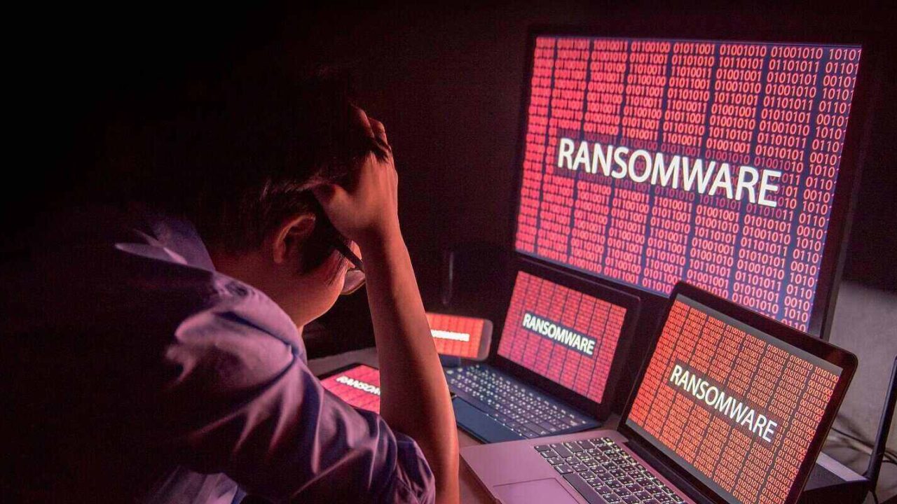 man confused and headache by ransomware attack on desktop screen