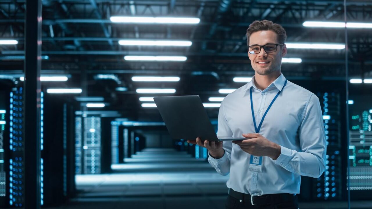caucasian male specialist using laptop in big data center