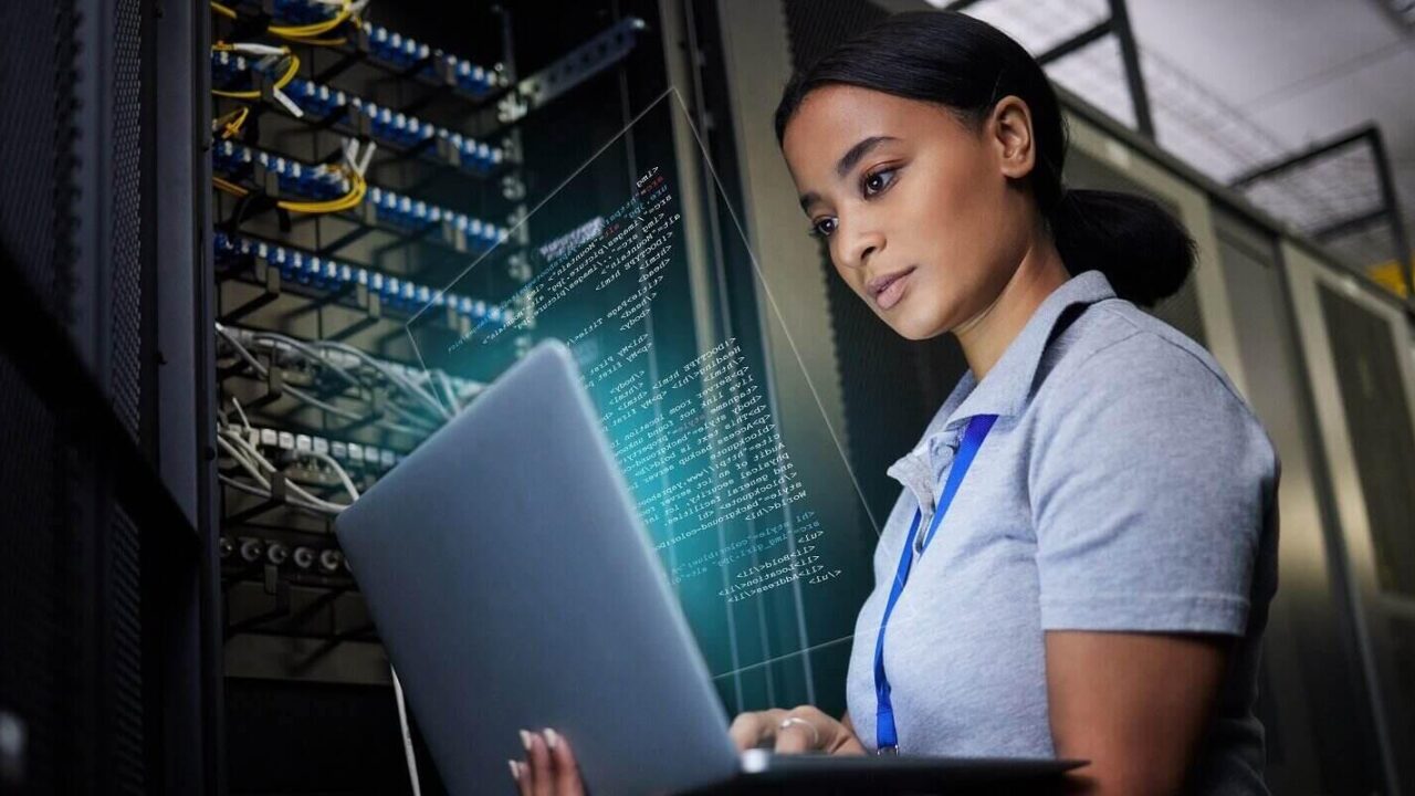 network and data center with a black woman it support engineer working in a dark server room