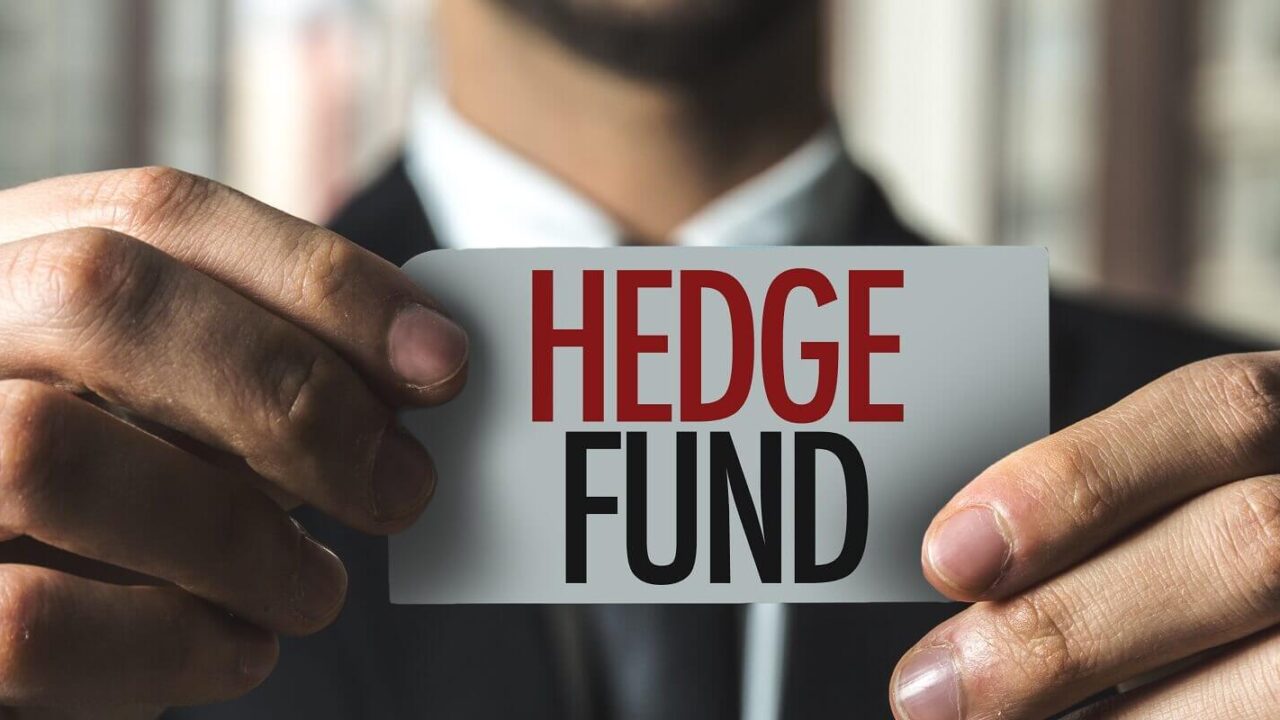 man holding hedge fund chit in hand